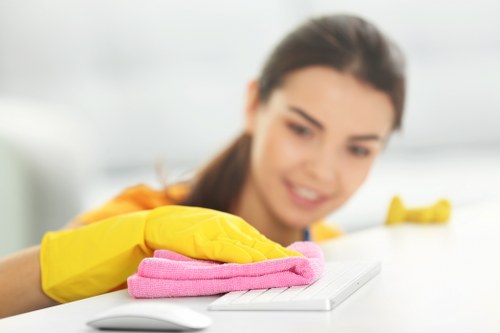 Cleaner working on a kitchen and bathroom domestic clean in Queens Park